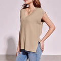 Camel and white V-neck sleeveless pullover vest with loose fit and striped or plaid patterns