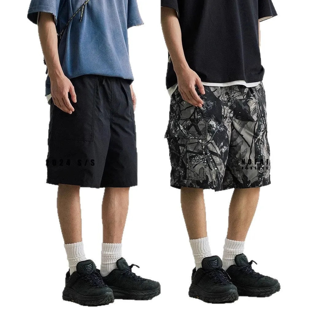 Loose fit straight-leg denim shorts on hanger, showing micro-elastic waistband and zip fly in army green colour.