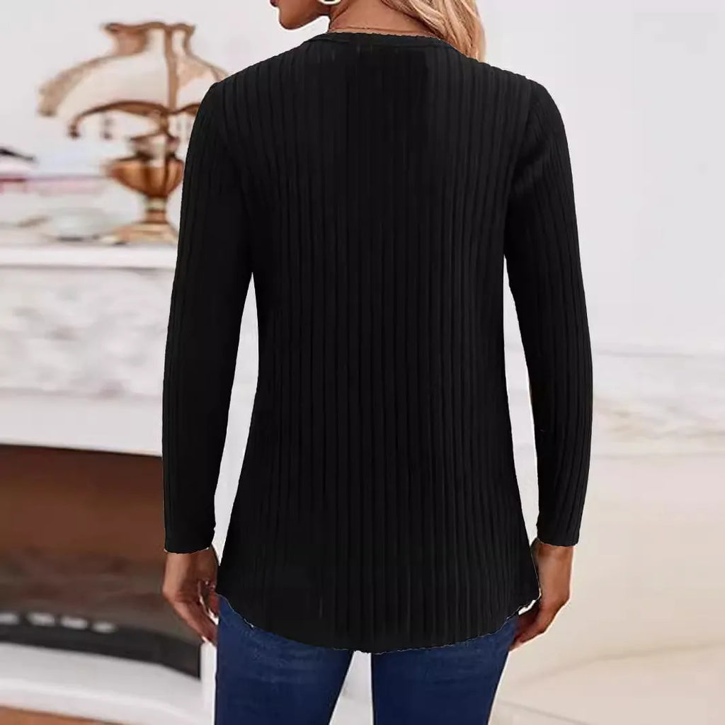 Solid colour casual knitted pullover sweater with a button detail on a hanger.