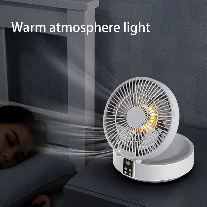 White portable rechargeable folding fan with night light and remote control on a desk