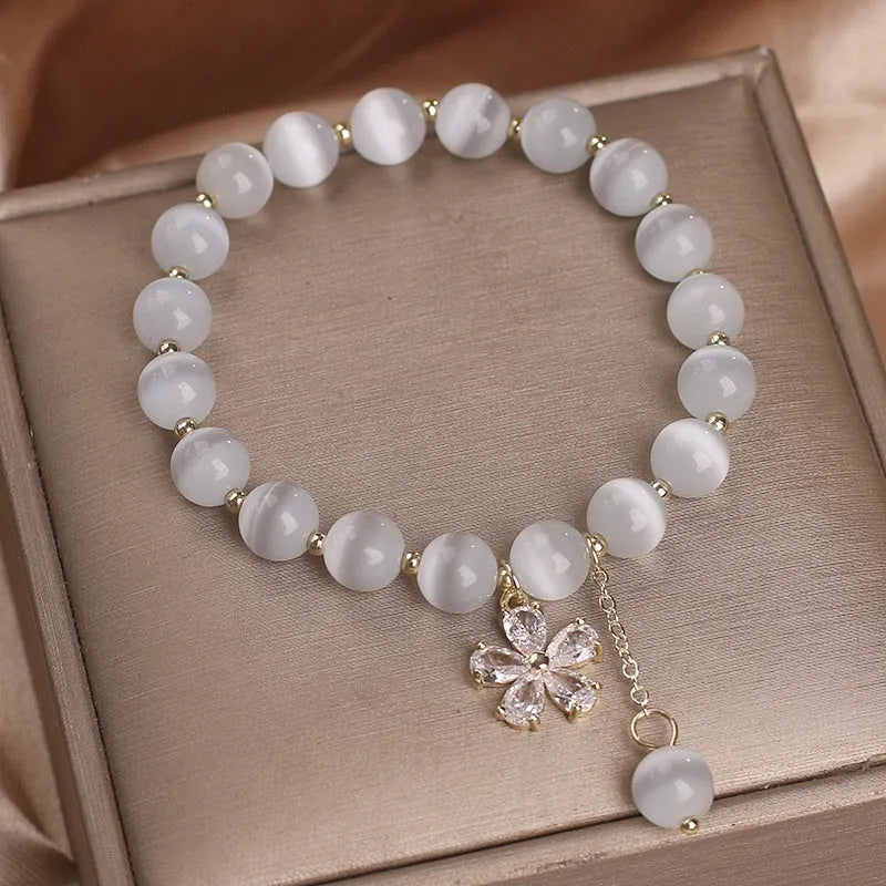 White cat's eye crystal bracelet with flower tassels and morganite safety buckle pendant