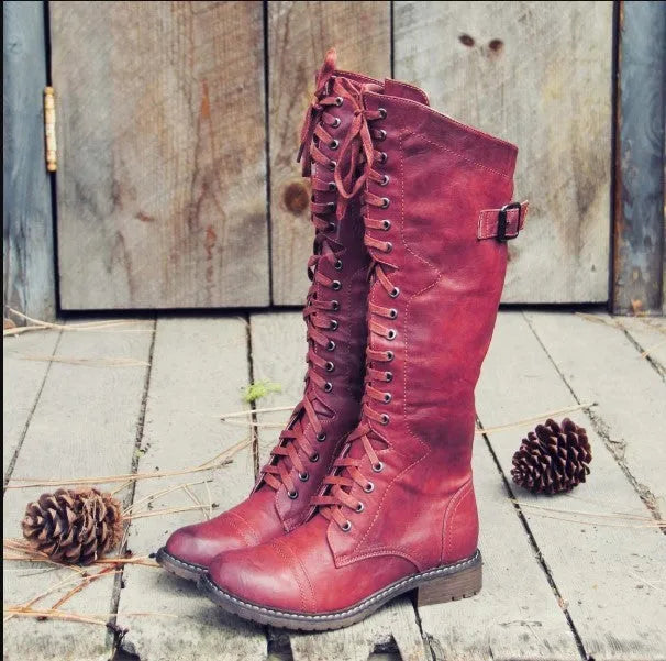 Women's black cross strap knight boots with side buckle fastening on artificial PU upper