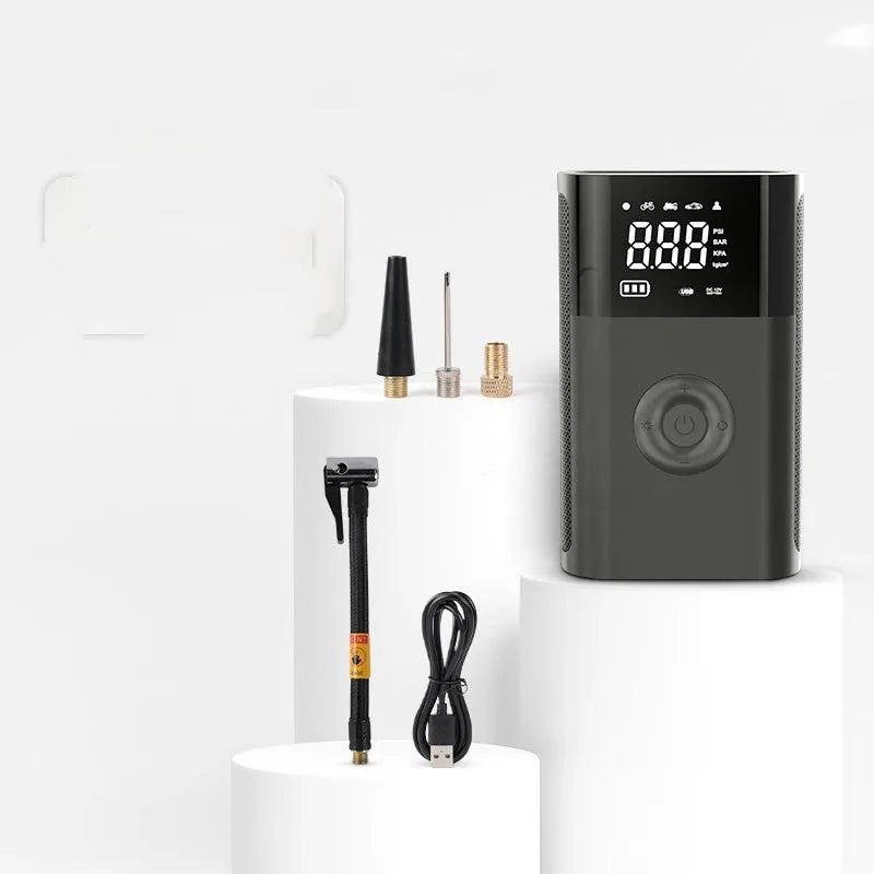 Wireless handheld digital tyre pump with LCD display, black ABS casing, and set of inflation nozzles.