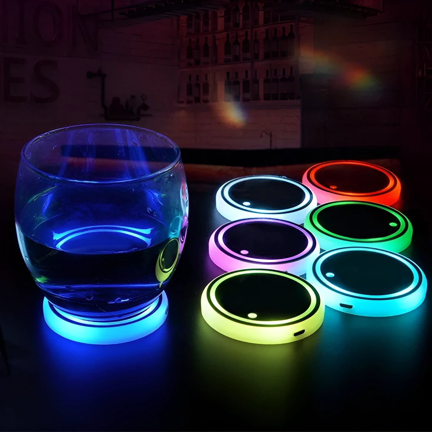 Colourful LED light-up coaster for car cup holder with USB cable on a car centre console.