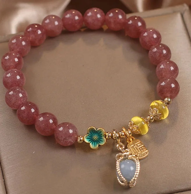 Red women's beaded bracelet with natural strawberry quartz stones, alloy metal, and rhinestone details.