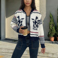 White women's cardigan with zipper front, lapel collar and jacquard contrast stripes