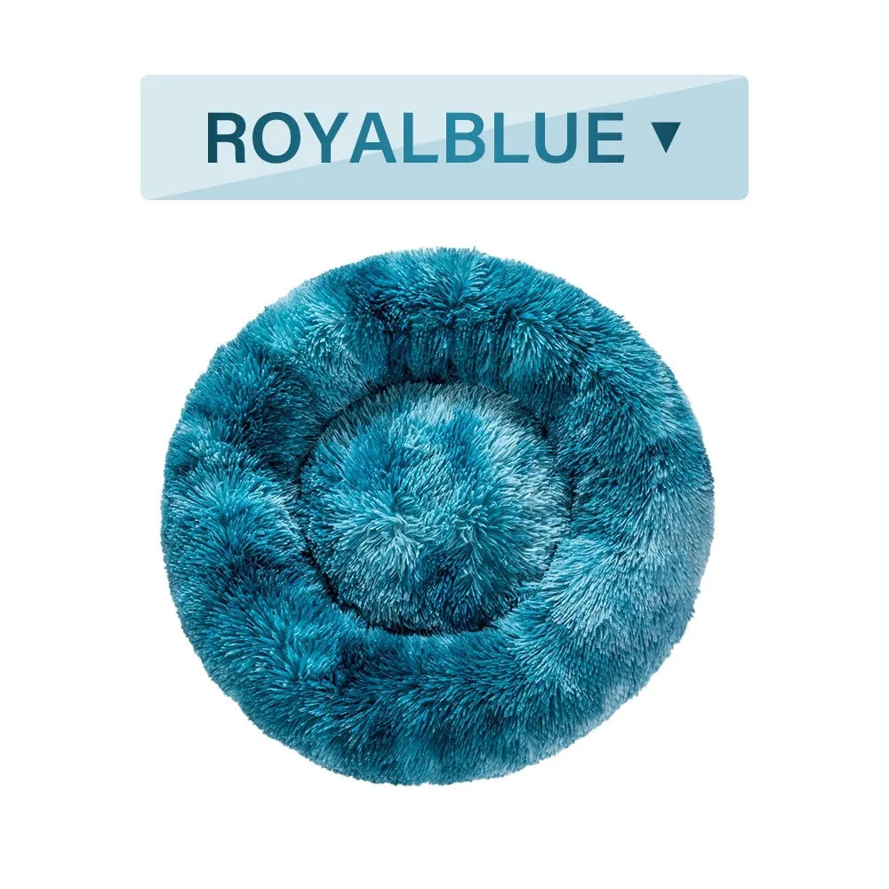 Fluffy donut-shaped dog bed with raised rim in plush fabric, available in multiple colours and four sizes