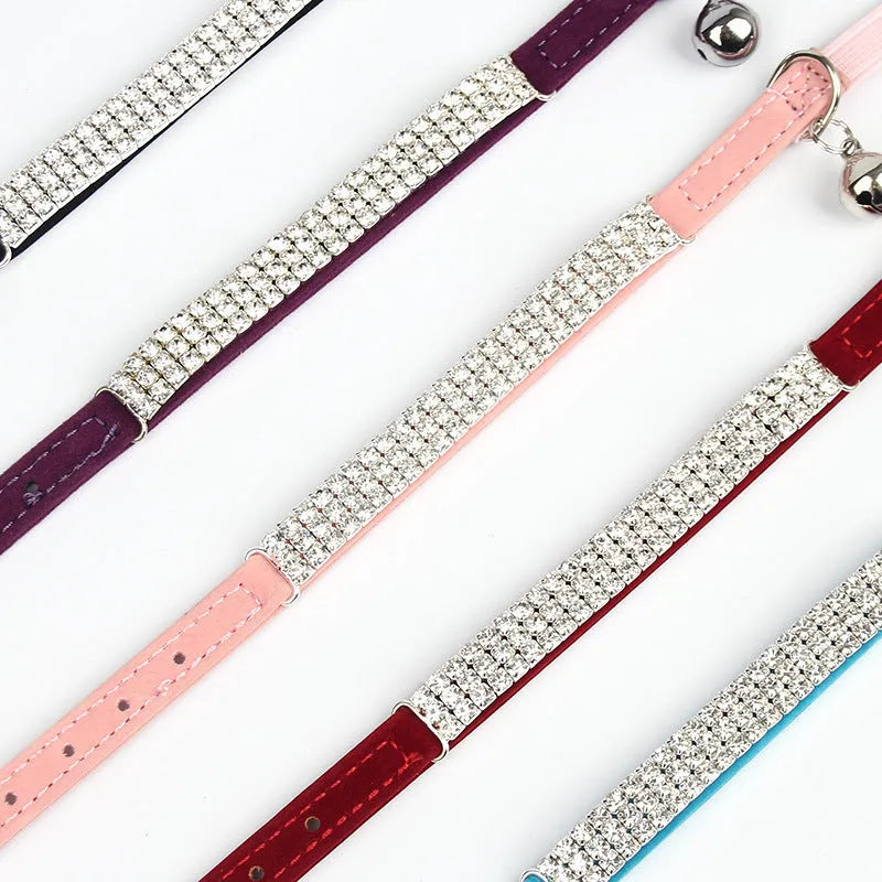 A soft red velvet cat collar with rhinestone decoration, showing the adjustable buckle.