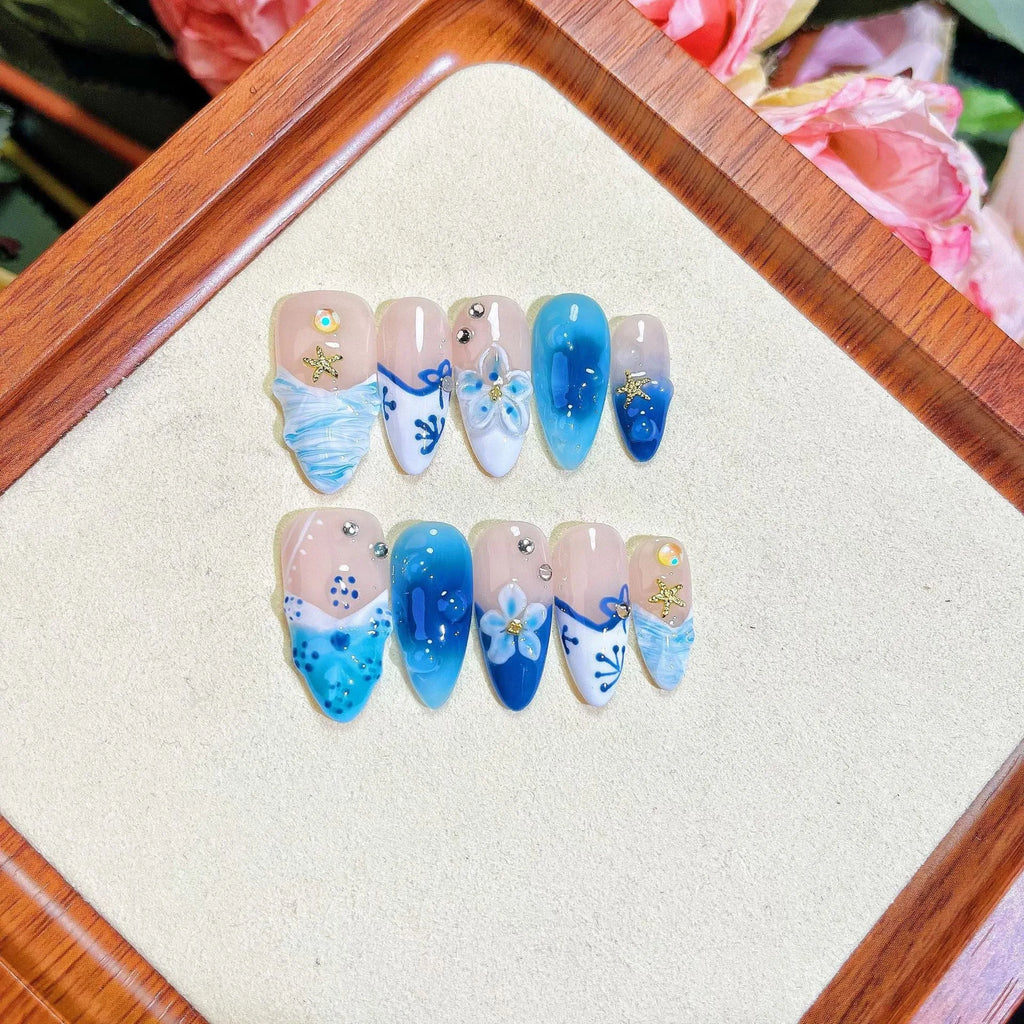 Blue carved transparent fake nails with hand-painted patterns in four sizes
