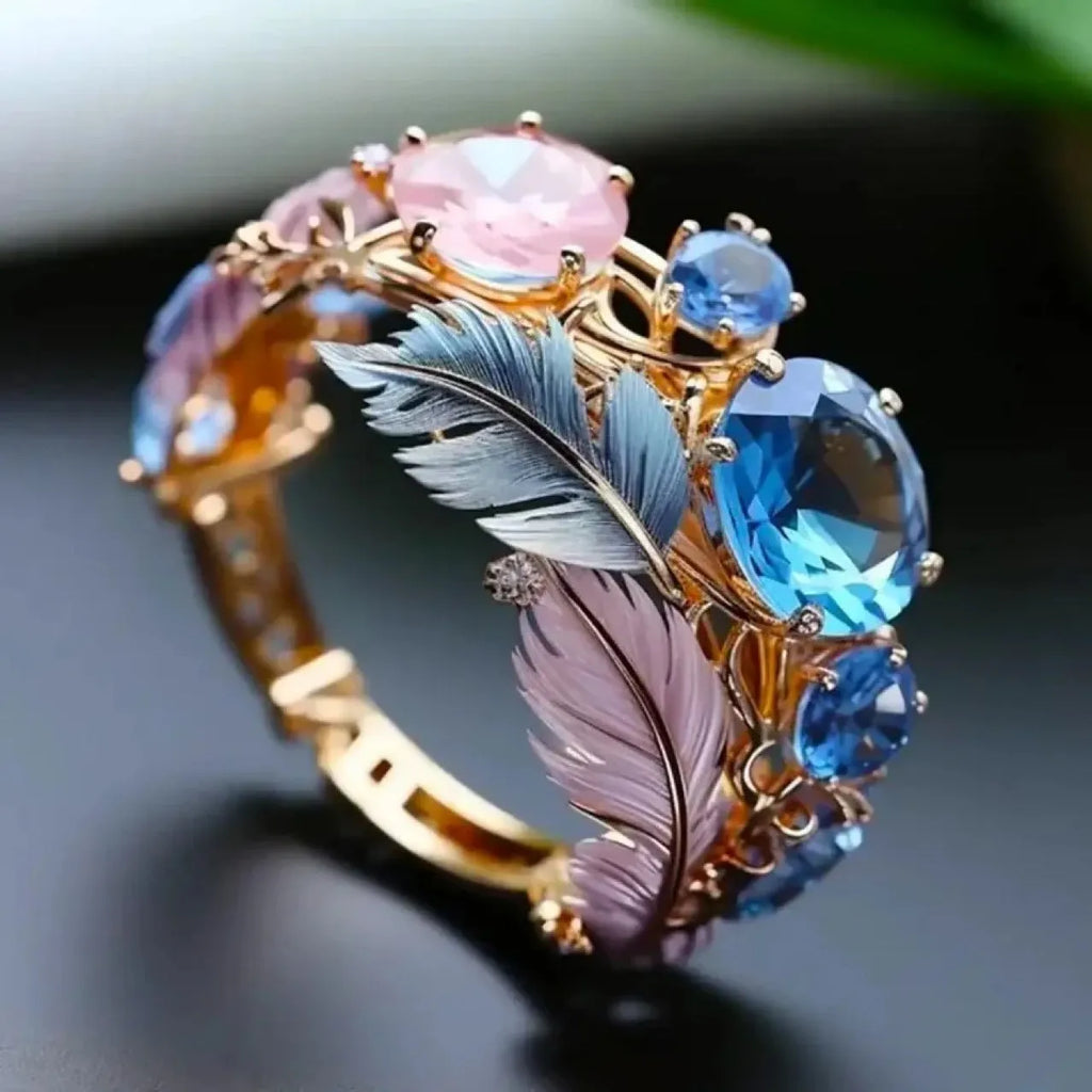 Gold brass geometric ring with embossed feather design and zirconia stone inlay