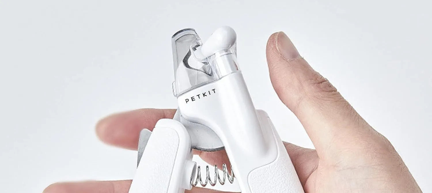White LED pet nail clippers for dogs and cats with a transparent safety guard and leather-like handle.