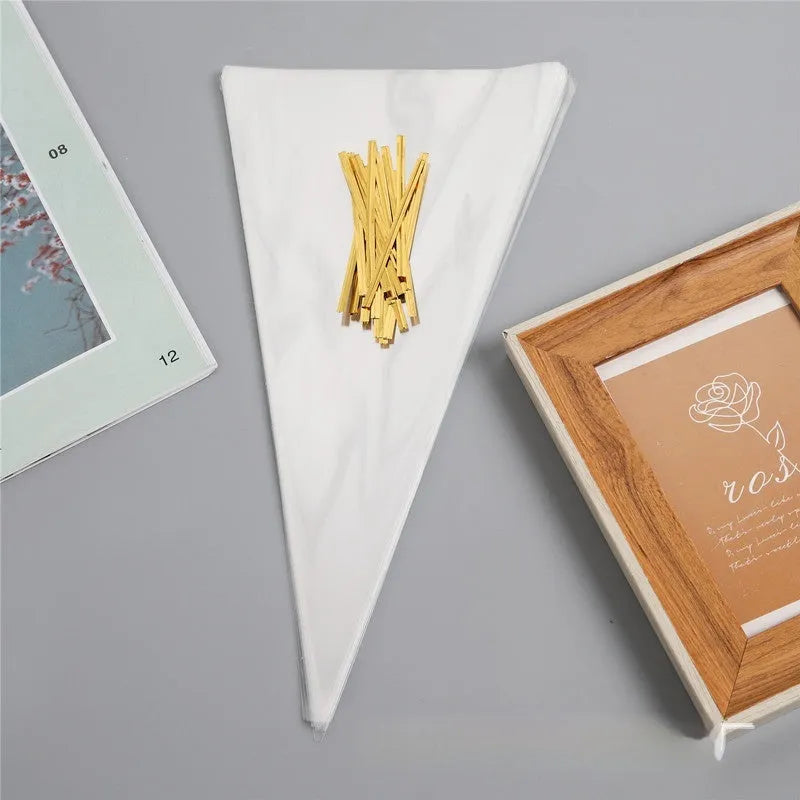 Clear triangle-shaped plastic packaging bag with a twisted wire tie closure on a white background.
