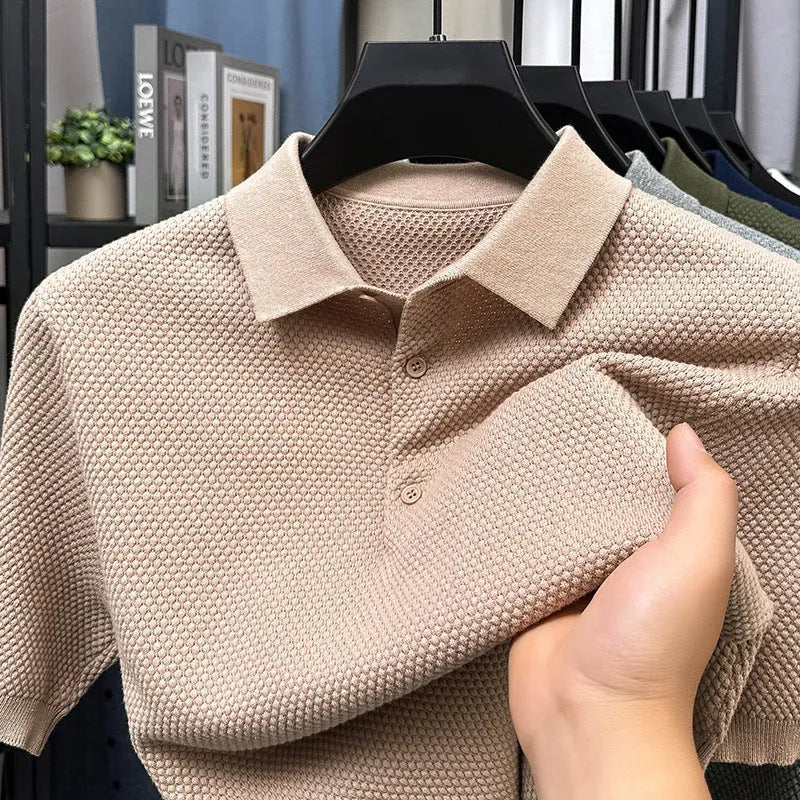 Loose-fitting short sleeve cotton pullover sweater in a neutral colour on a hanger.