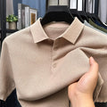 Loose-fitting short sleeve cotton pullover sweater in a neutral colour on a hanger.