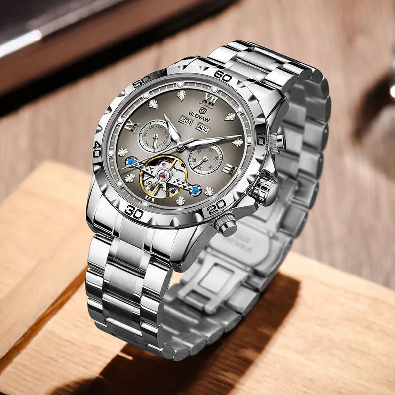 Men's automatic mechanical watch with stainless steel strap on wrist, showing blue dial and silver case variant.