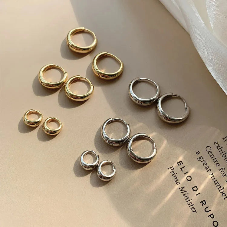 Women's geometric water drop earrings in gold and silver finishes showing three size variations