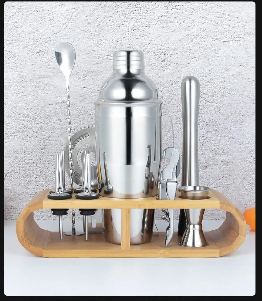 Silver 23-piece stainless steel and acrylic home cocktail set with bartender tools laid out.