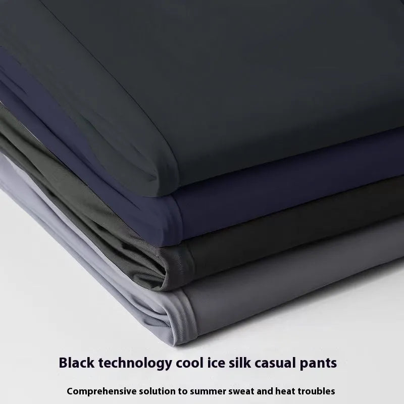 Man wearing black loose-fit straight-leg Ice Silk trousers with an elastic waistband for leisure wear.
