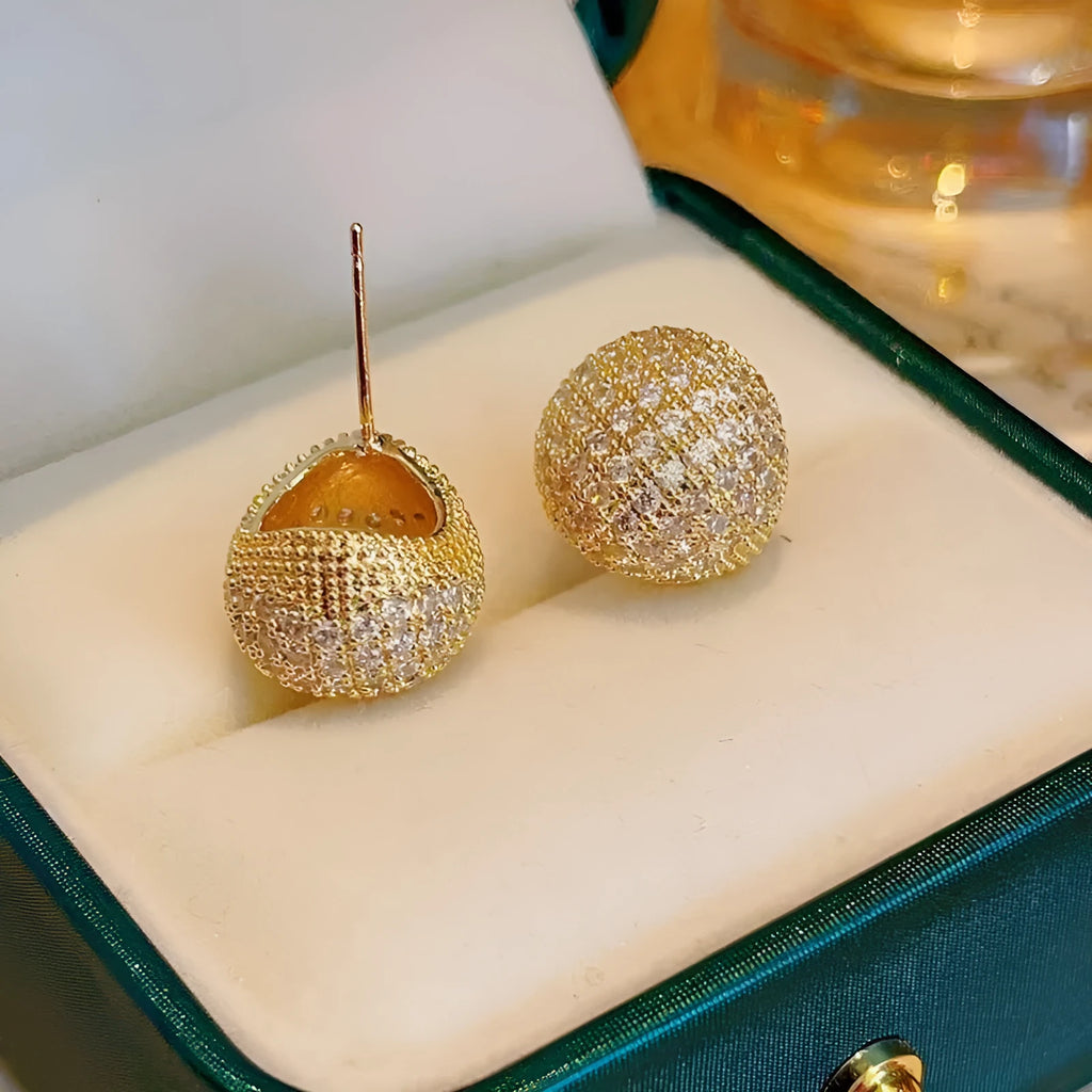 Gold and white geometric drop earrings with flashing lights and spherical elements