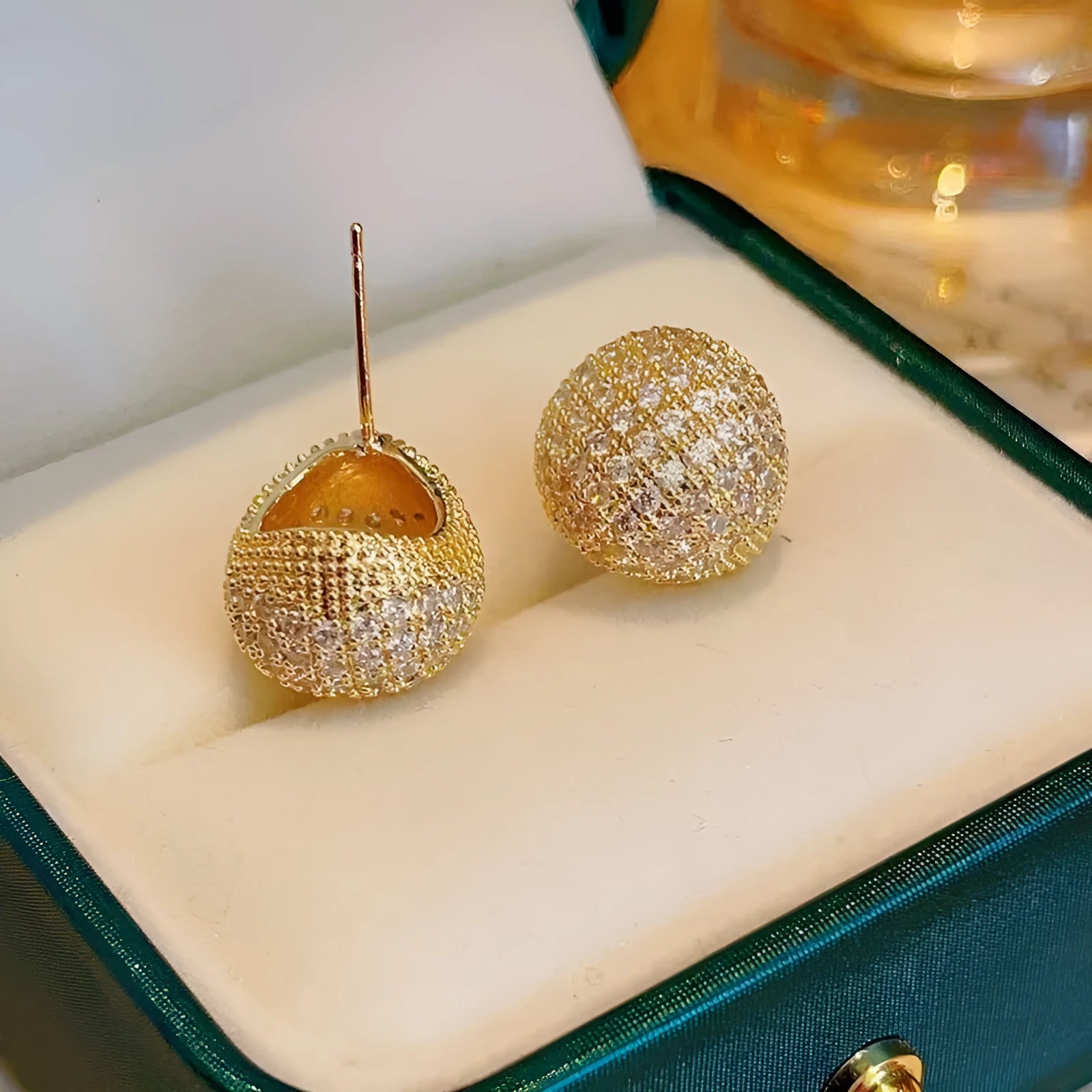 Gold and white geometric drop earrings with flashing lights and spherical elements