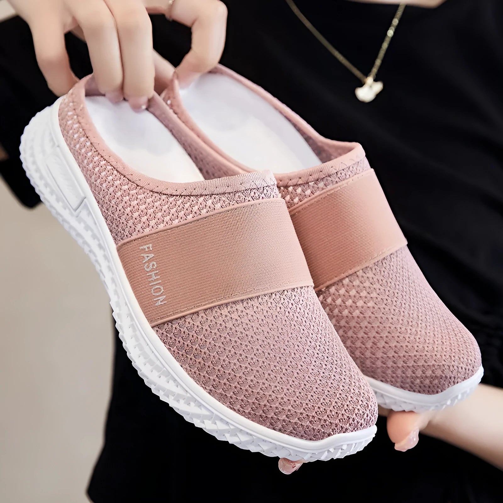 Women's black breathable mesh casual shoes with hollow-out details and a flat round toe.