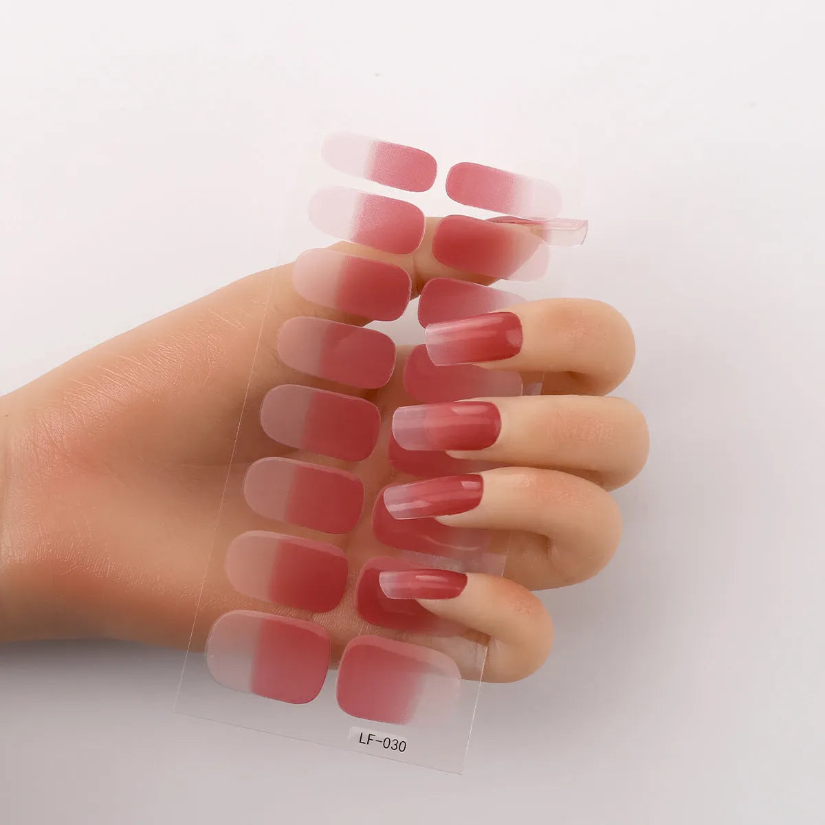 Sheet of 16 small manicure nail art stickers showing cross, rose, tulip, and cartoon designs.