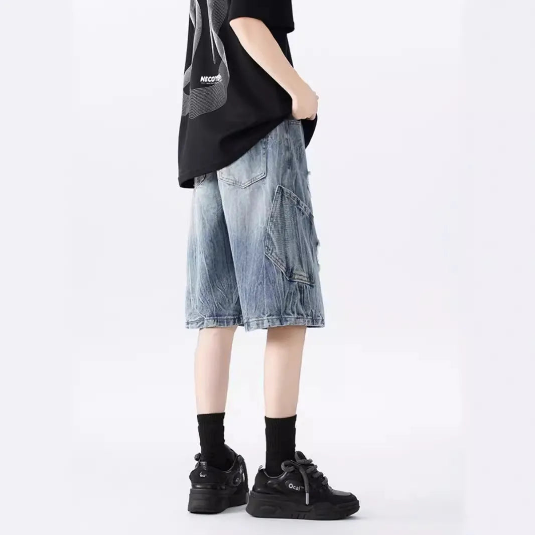 Men's loose fit distressed denim shorts with ripped knee detailing in retro style