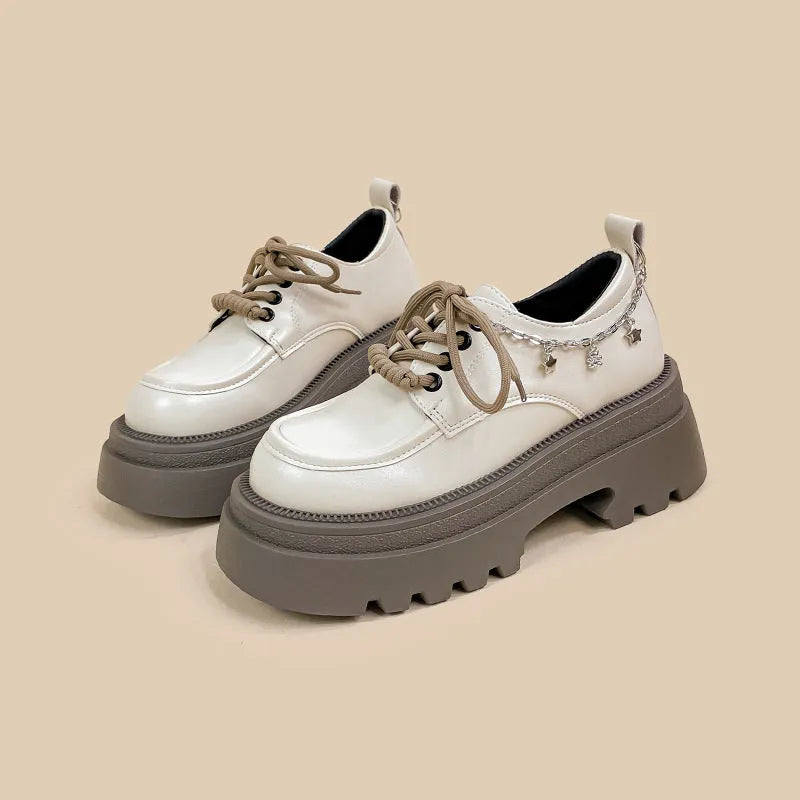 White platform Mary Jane shoes with chunky heel and front lace-up, featuring XINGX bear design.