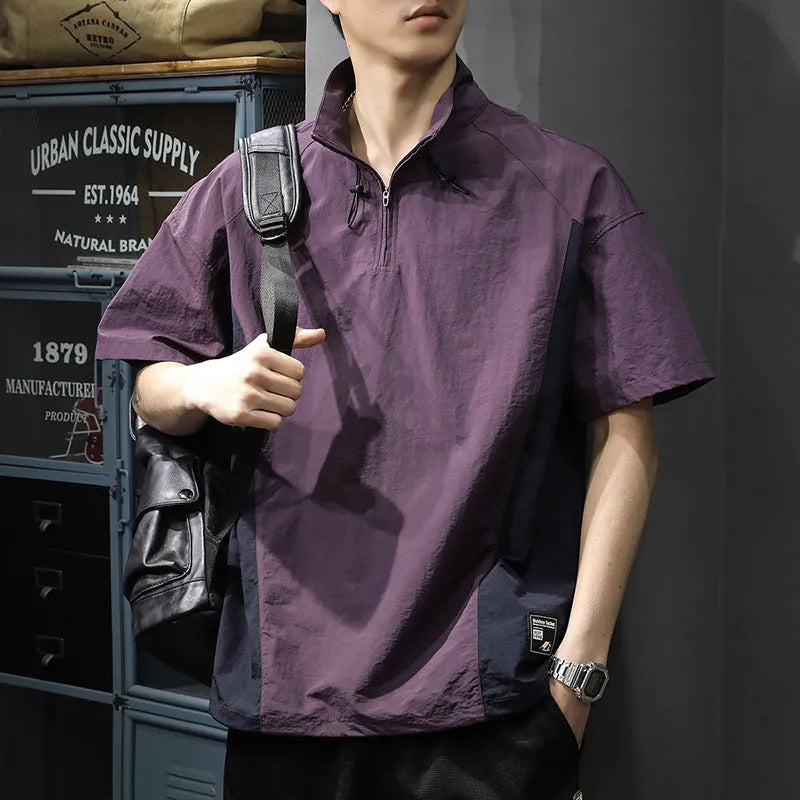 Brown men's loose fit short sleeve shirt with a half-zip stand collar, shown flat.