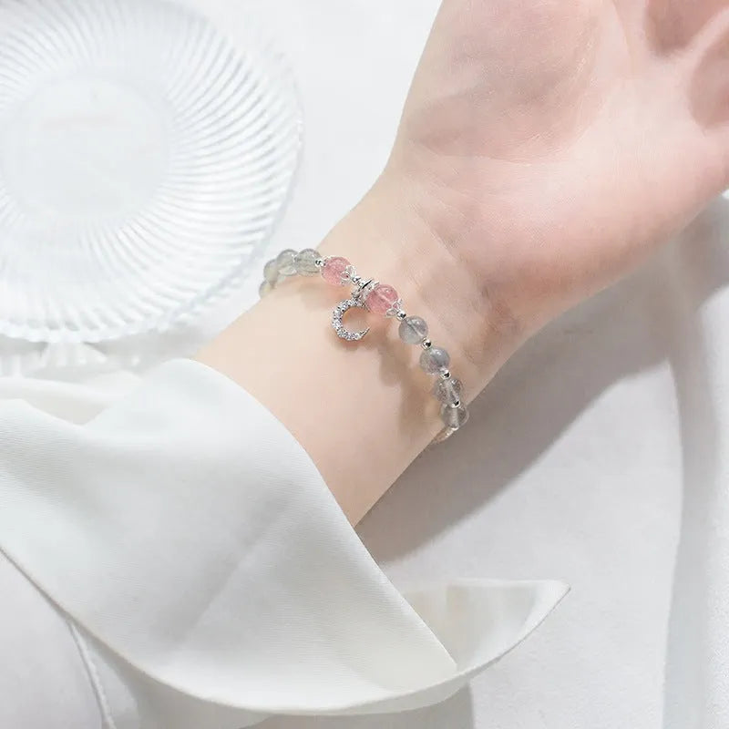 Handmade silver-tone adjustable bracelet with a moonstone bead and crescent moon charm.