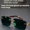 Pair of dark green frameless crystal sunshade glasses with case and cleaning cloth