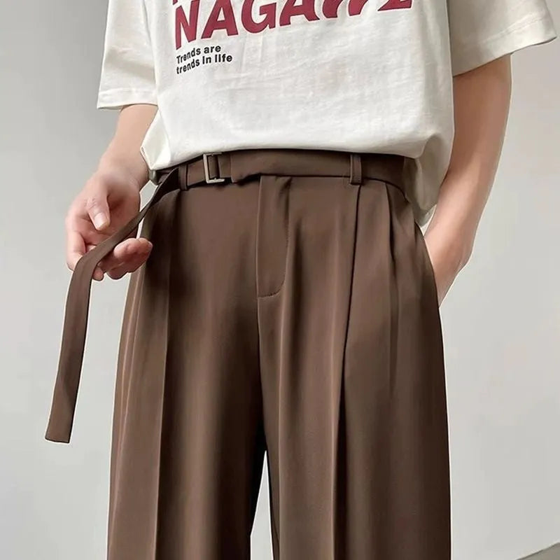 Man wearing thin straight-cut wide leg casual trousers in black, showcasing the loose fit and straight leg opening.