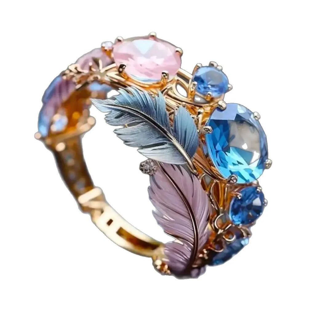 Gold brass geometric ring with embossed feather design and zirconia stone inlay