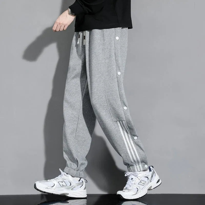 Men's black loose-fit cotton blend sweatpants with ankle ties and a drawstring waist.