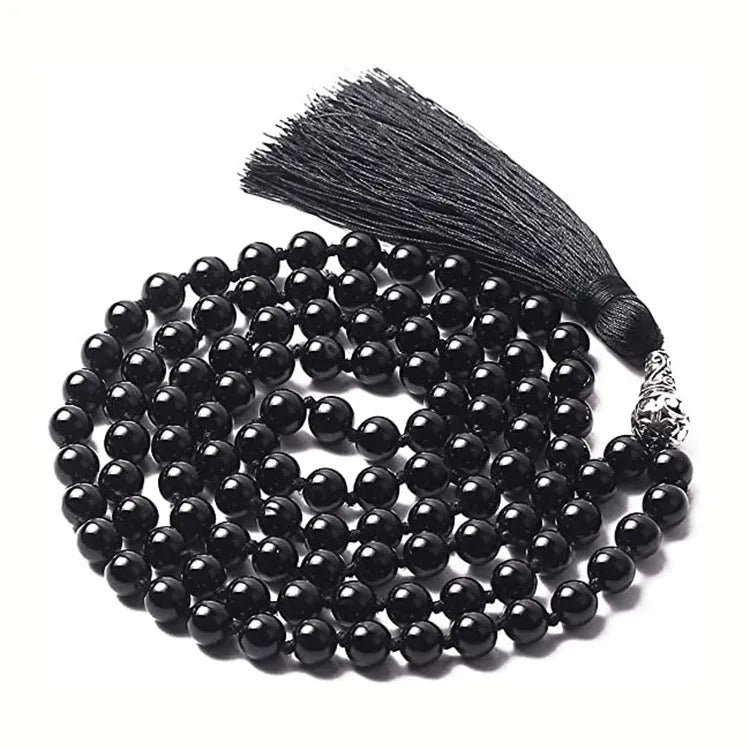 Long agate tassel necklace with geometric beads in multiple natural stone colours on a white background.