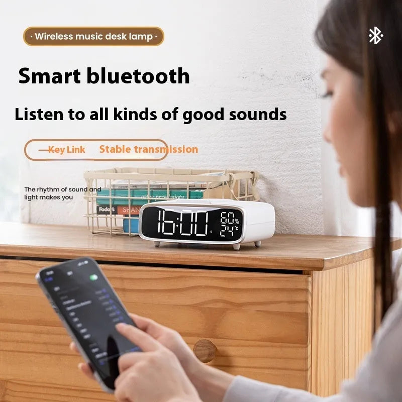 White wireless charging Bluetooth speaker with night light function on bedside table