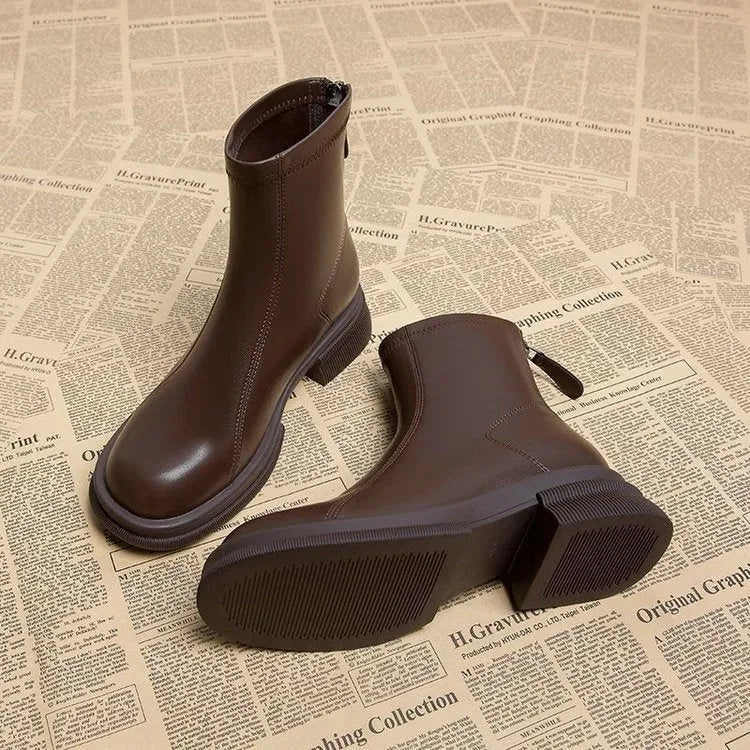 Women's black ankle boots with flat heel, back zipper, and round toe