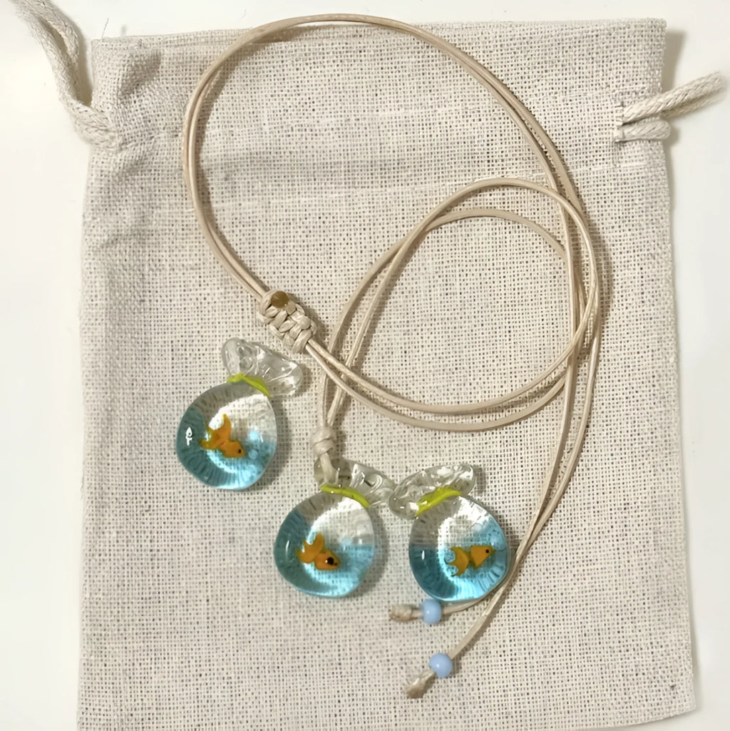 Women's coloured glaze small fish lucky bag pendant on a cotton linen clavicle chain necklace.
