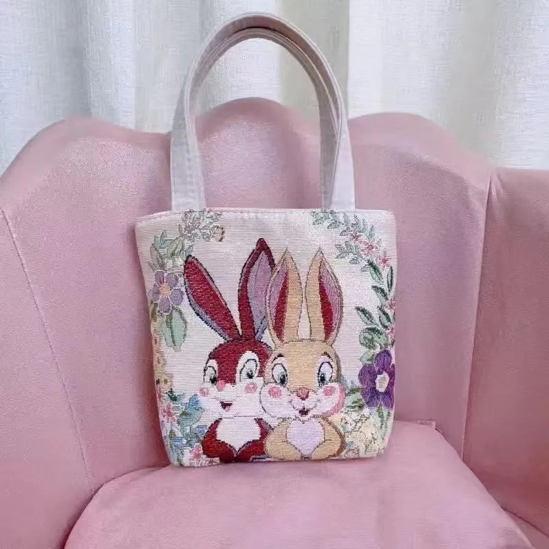 Double-sided embroidered canvas bag with gold wire detailing showing botanical pattern