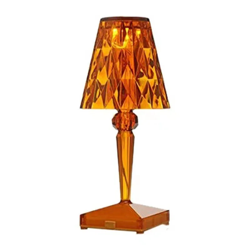 Rose gold portable touch night light with acrylic lamp holder on a surface