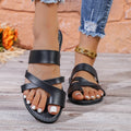 Men's simple one-line beach slippers in black with a round head and hollow-out design on a rubber sole.