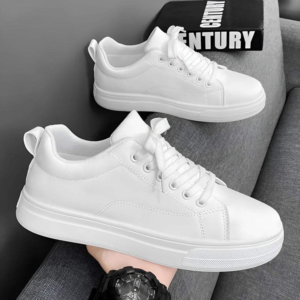 Men's low-top Korean-style sneakers in white, black, and black with white sole colours on a plain background.