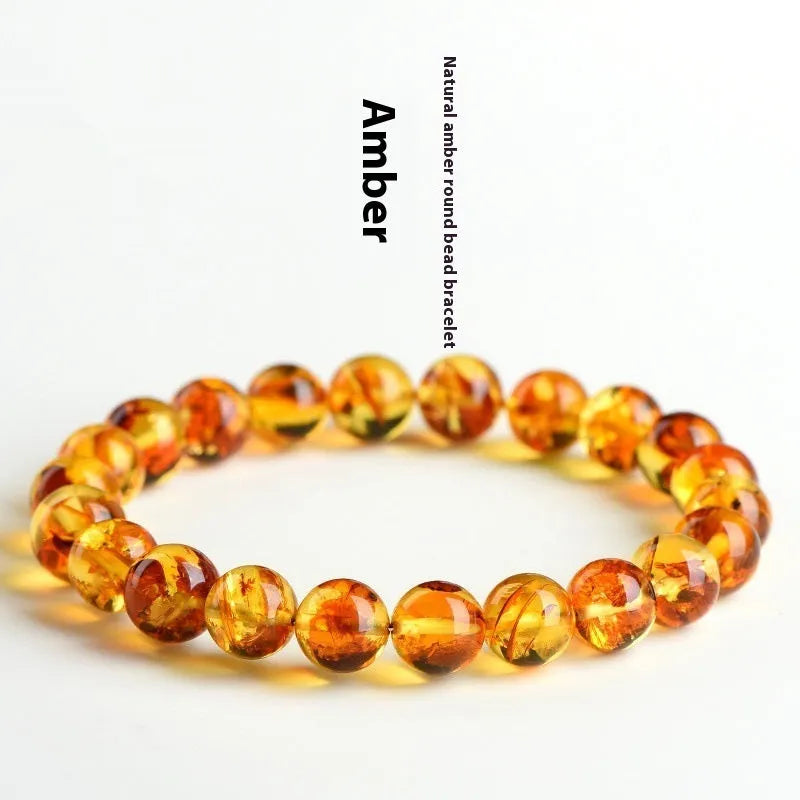 Natural yellow piebald amber beaded bracelet with geometric polished beads on a white background.