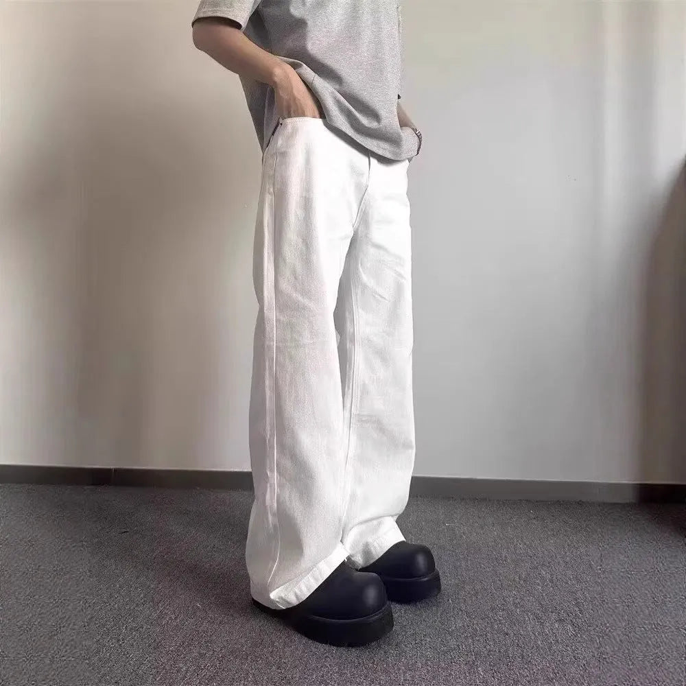 Men's straight-cut white wide-leg denim jeans with a mid waist and zipper fly