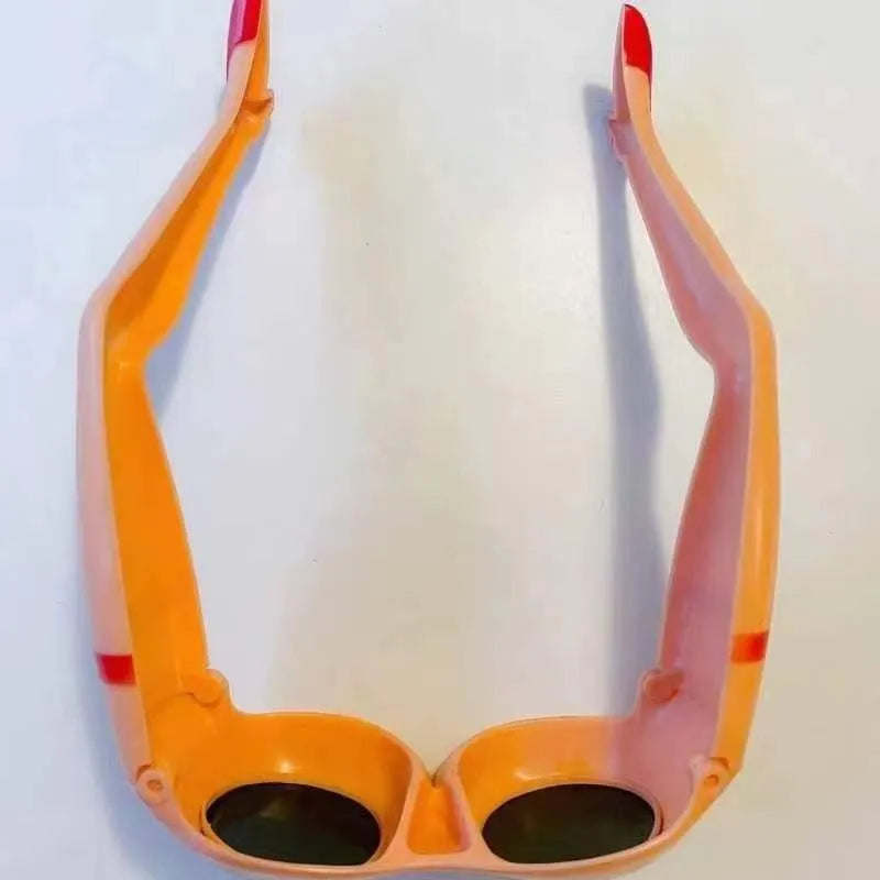 Orange oversized novelty plastic sunglasses for parties and travel.