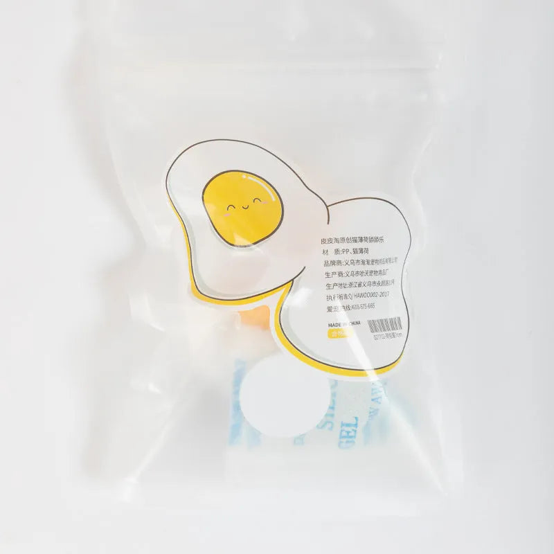 Soft plush catnip ball toy with adhesive base sticking to a wall for interactive feline play