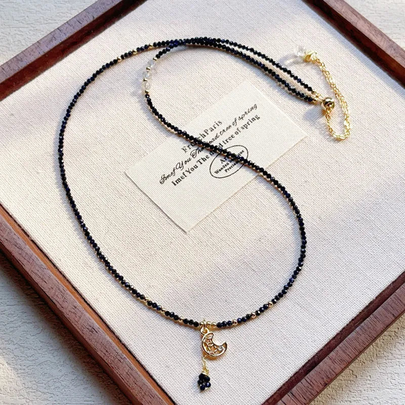 Close-up of a women's multi-layer bracelet with three interlinked rings made from blue and gold cut sand stone.