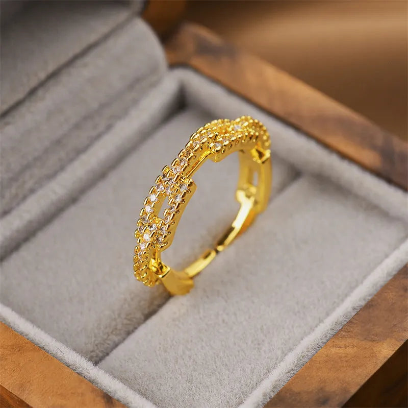 Korean fashion women's open geometric ring in electroplated gold colour on a plain background.
