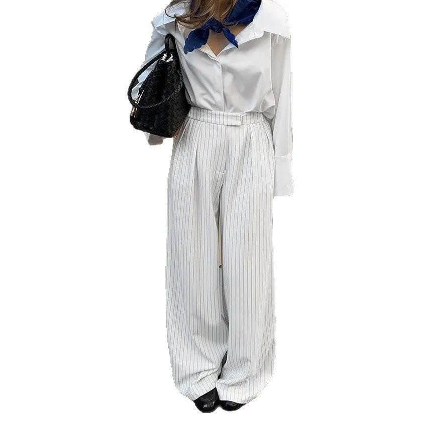 White striped wide-leg trousers with a front zip closure on a model.