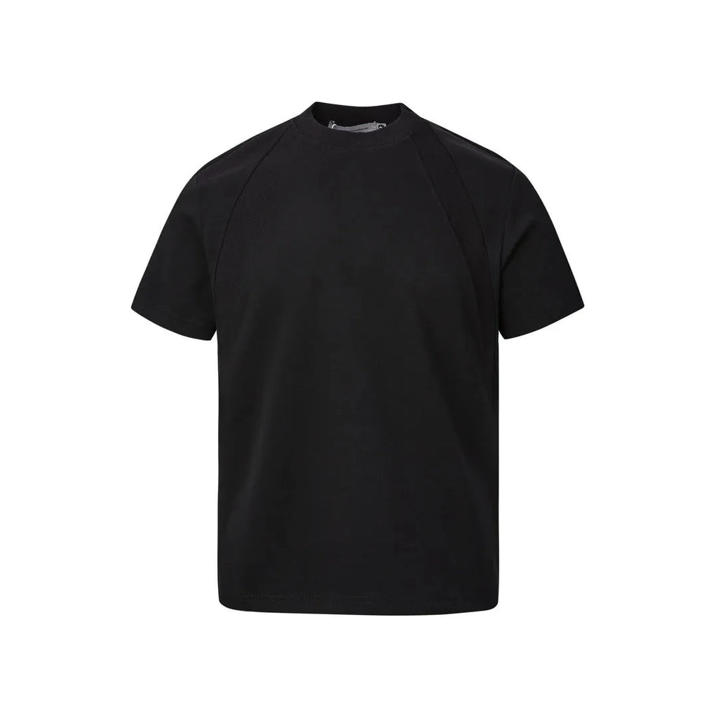 Man wearing a loose fit grey short sleeve top with visible air layer stitching texture.